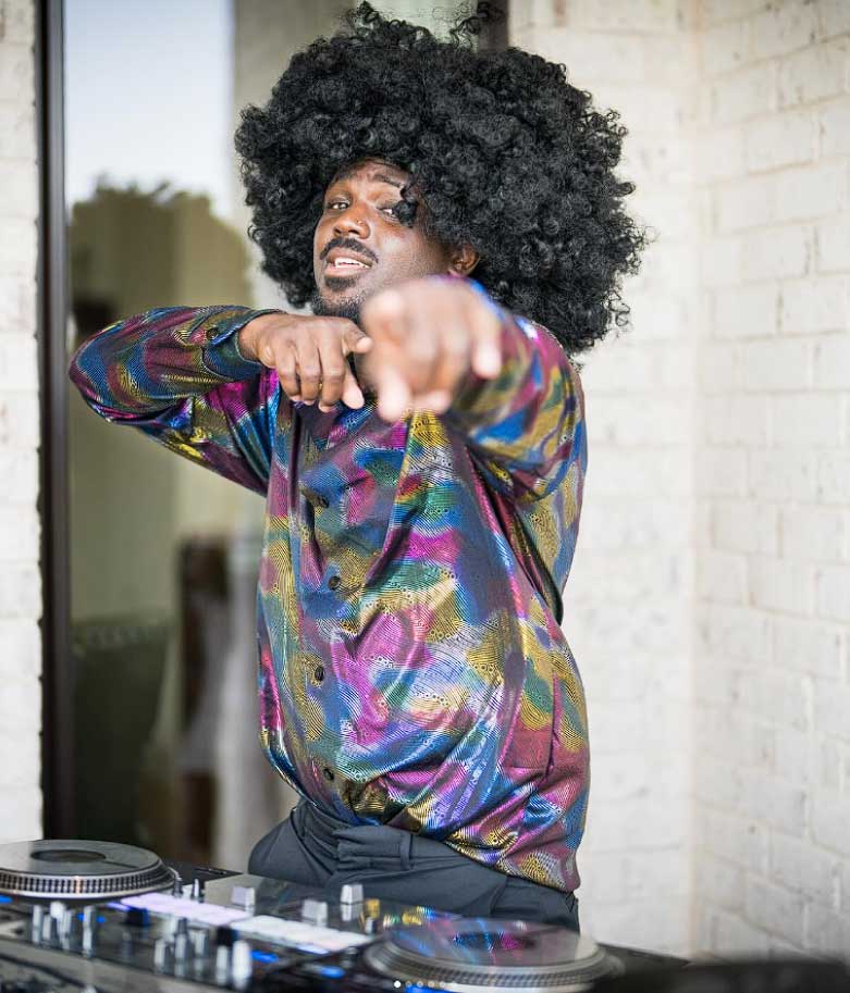 Professional DJ and MC engaging guests at a corporate or wedding event with high-energy music and professional hosting