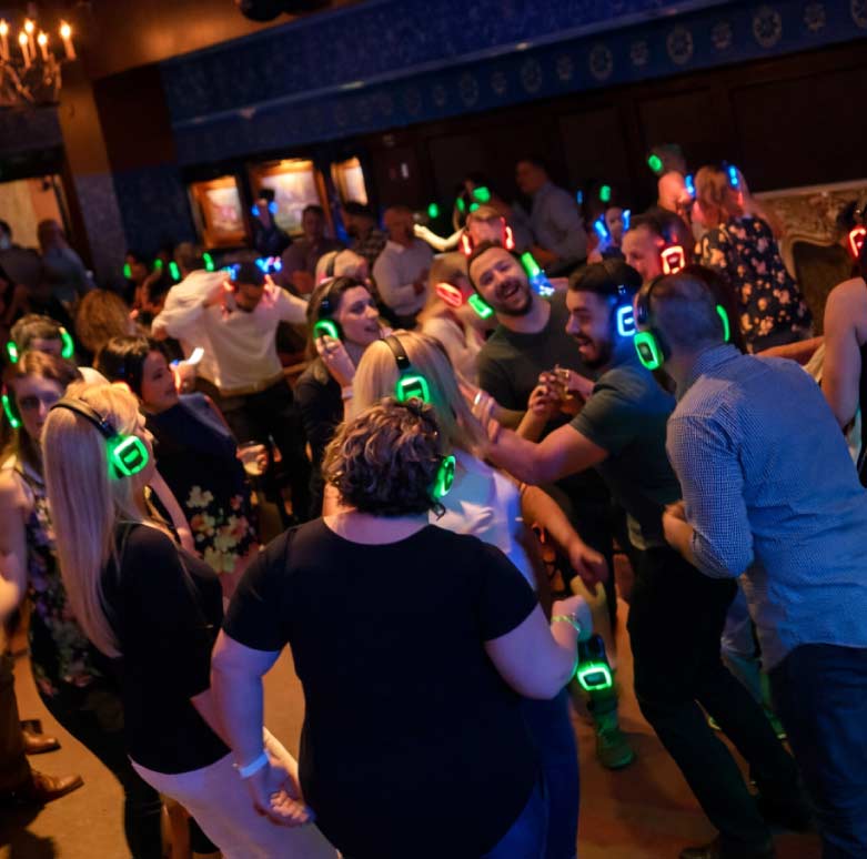Guests playing Cosmic Bingo with neon lights and music at a corporate or social event in Dallas–Fort Worth