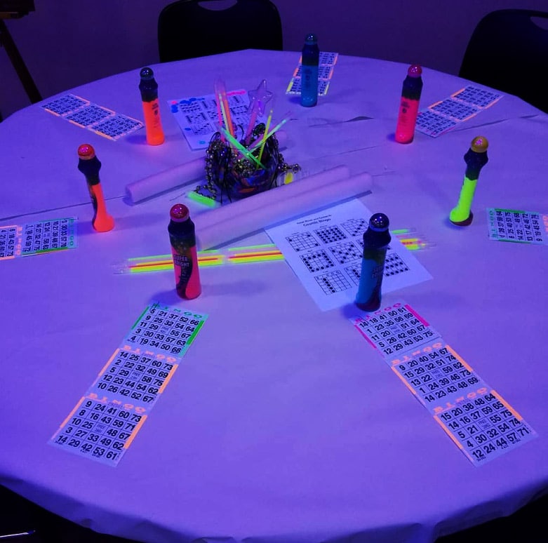Cosmic Bingo entertainment in Fort Worth featuring interactive bingo gameplay, music-driven hosting, and glowing neon visuals for a corporate event