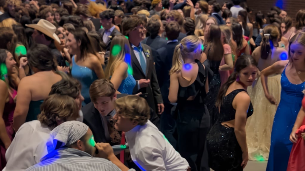 Silent disco wedding reception in Grand Prairie TX with guests wearing wireless headphones and dancing
