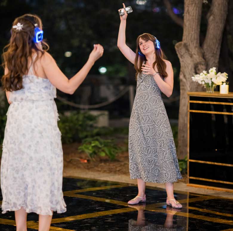 Professional DJ and MC engaging guests at a corporate or wedding event with high-energy music and professional hosting