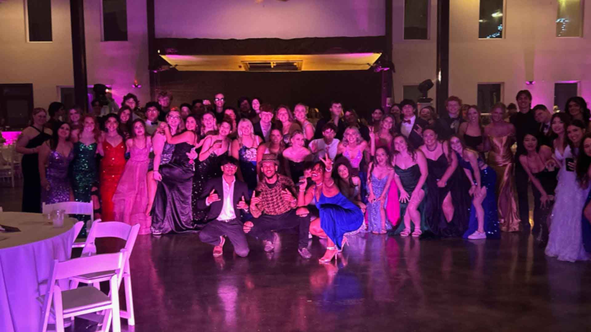 Professional DJ and MC engaging guests at a corporate or wedding event with high-energy music and professional hosting