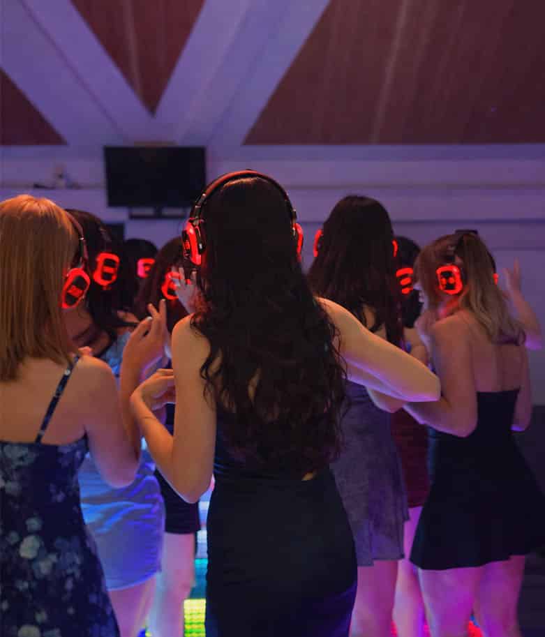 Silent disco wedding reception in Grand Prairie TX with guests wearing wireless headphones and dancing