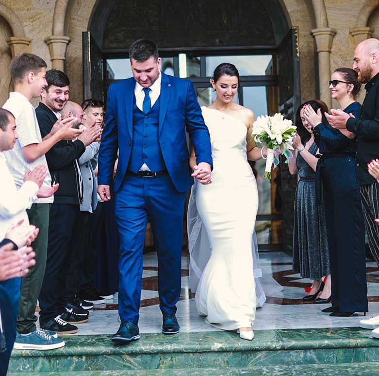 Bride and groom exiting a church after their wedding ceremony