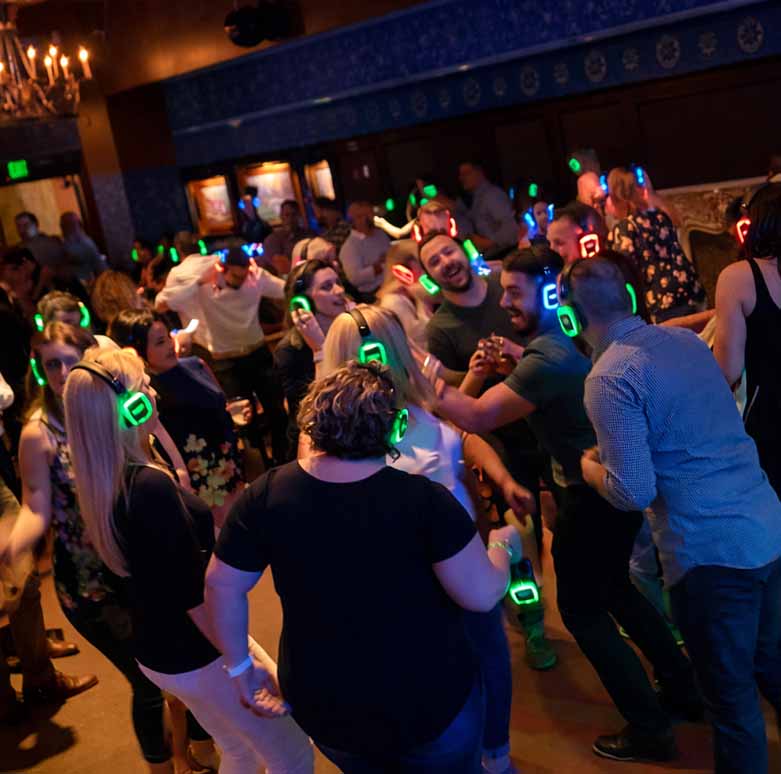 Guests participating in a silent disco experience at a corporate event in Dallas